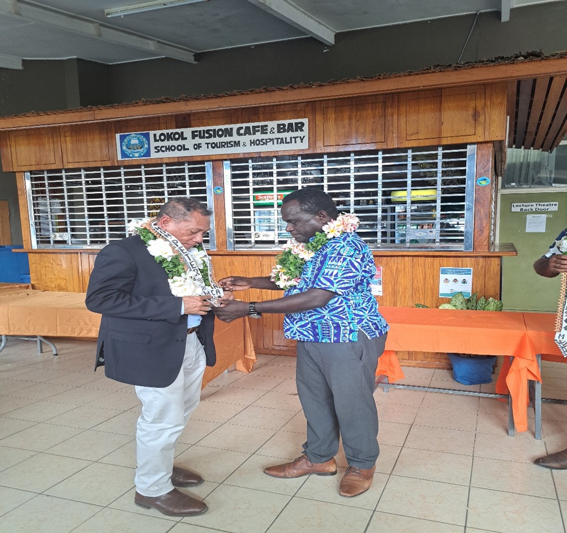 MCA’s new Minister, Hon. Fredrick Kologeto presenting a gift to the outgoing Minister, Honourable Peter Shanel Agovaka