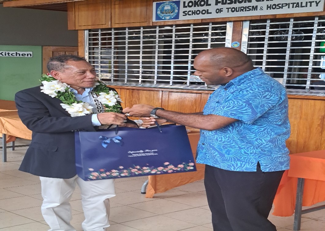 Outgoing Minister, Hon. Peter Shanel receiving a gift from Brian Halisanau, Director of the Civil Aviation Authority Solomon Islands (CAASI)