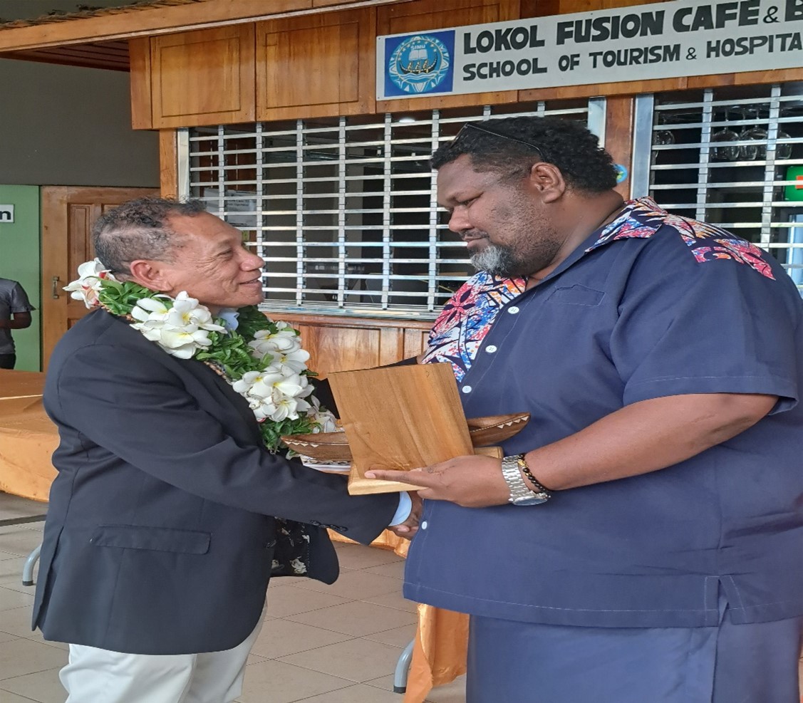 Calvin Ziru of Telecommunications Commission Solomon Islands (TCSI) presenting a gift to outgoing Minister, Hon. Peter Shanel